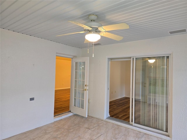 spare room with ceiling fan and french doors