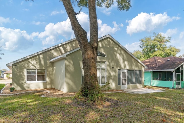 rear view of property with a patio area and a lawn