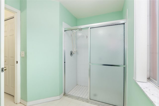 bathroom with a shower with shower door