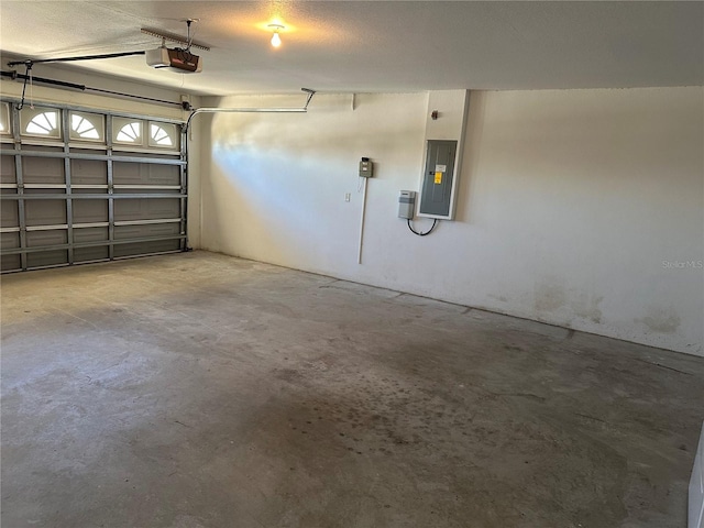 garage featuring electric panel and a garage door opener