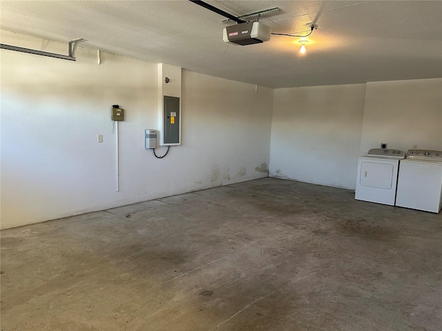 garage with separate washer and dryer, electric panel, and a garage door opener