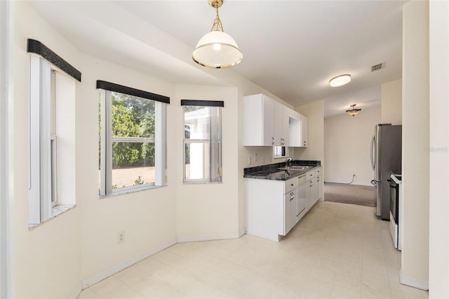 kitchen featuring white cabinets, sink, decorative light fixtures, white electric range oven, and stainless steel refrigerator