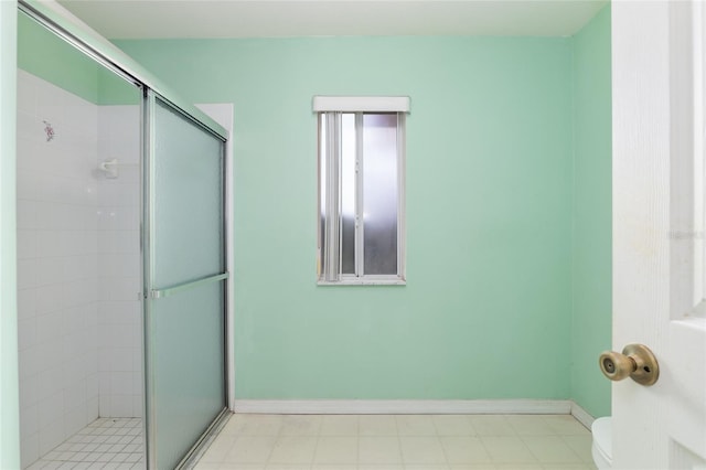 bathroom with toilet and a shower with shower door