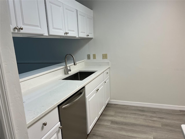 kitchen featuring dishwasher, white cabinets, light hardwood / wood-style floors, and sink