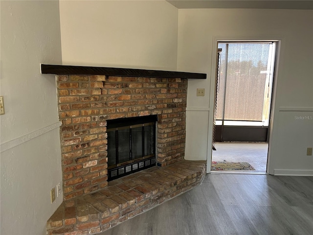 interior details featuring a fireplace and hardwood / wood-style floors