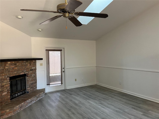 unfurnished living room featuring a brick fireplace, ceiling fan, dark hardwood / wood-style flooring, and vaulted ceiling