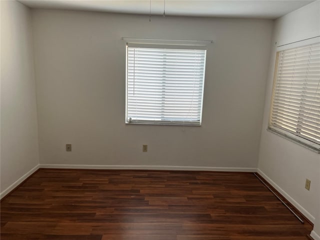 spare room with dark hardwood / wood-style floors