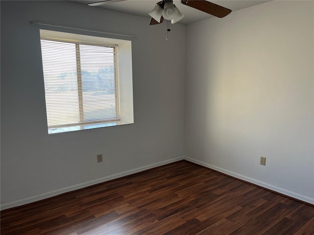 empty room with dark hardwood / wood-style floors and ceiling fan