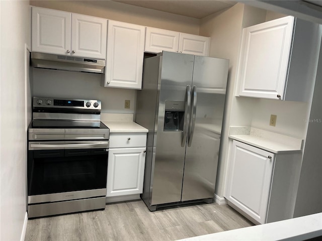 kitchen featuring appliances with stainless steel finishes, light wood-type flooring, and white cabinetry