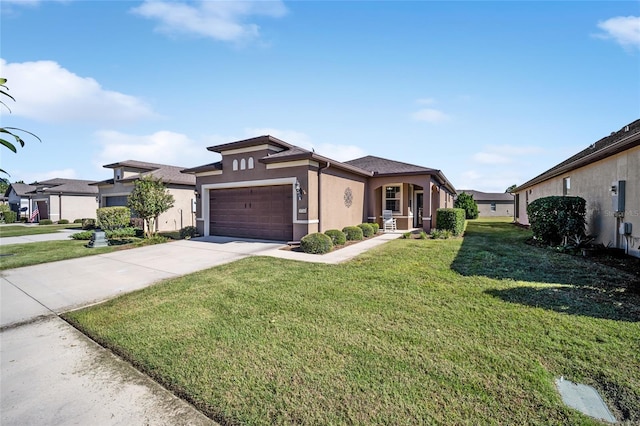 view of front of home with a front yard and a garage