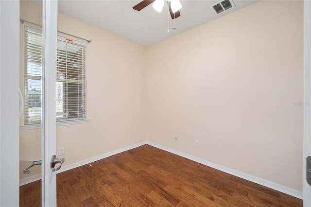 spare room featuring ceiling fan and dark wood-type flooring