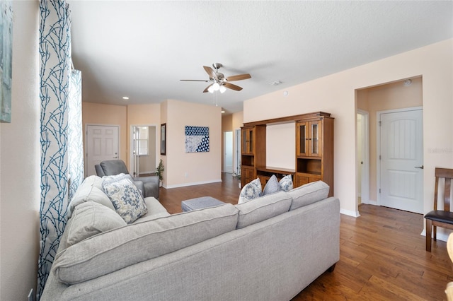 living room featuring dark hardwood / wood-style floors and ceiling fan