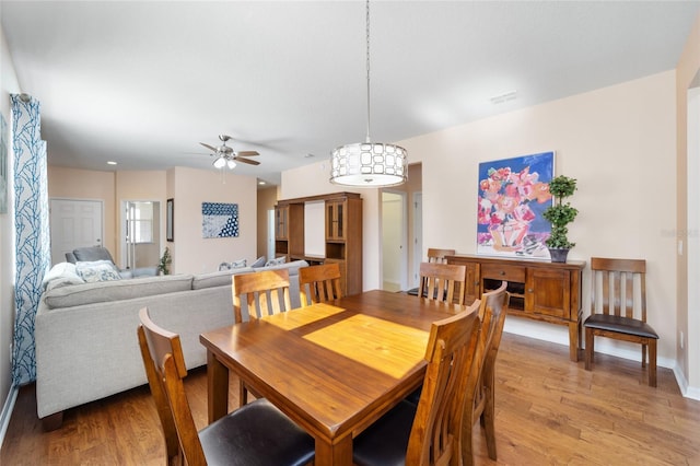 dining room with ceiling fan and light wood-type flooring