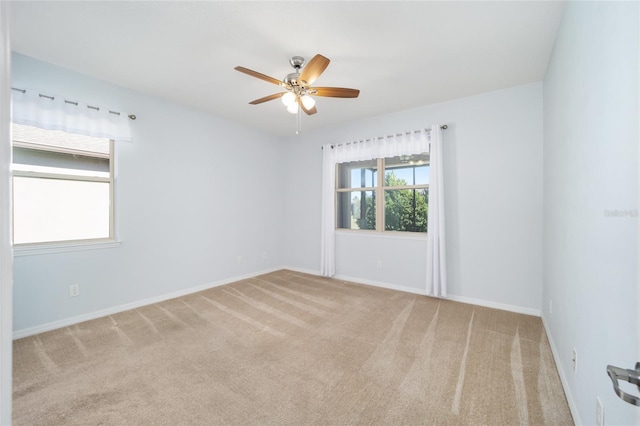 unfurnished room featuring ceiling fan and light colored carpet