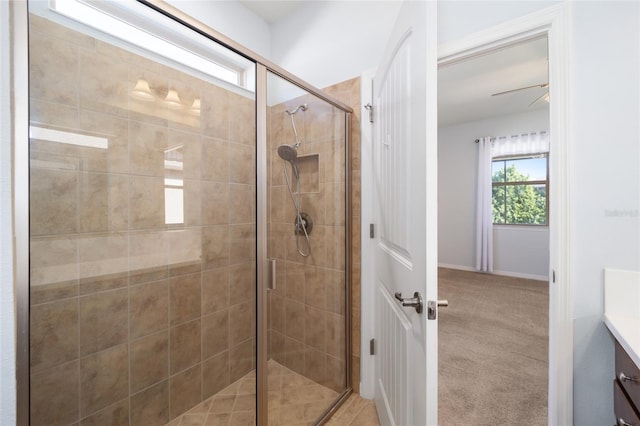 bathroom featuring ceiling fan, vanity, and an enclosed shower