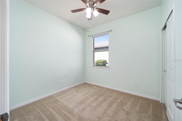 carpeted empty room featuring ceiling fan