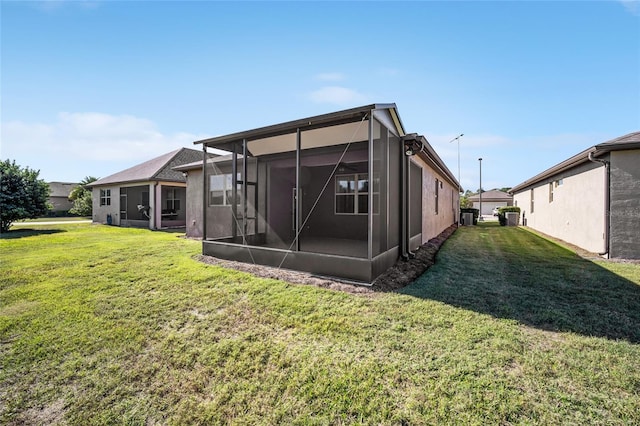 back of property with a sunroom, central AC unit, and a yard