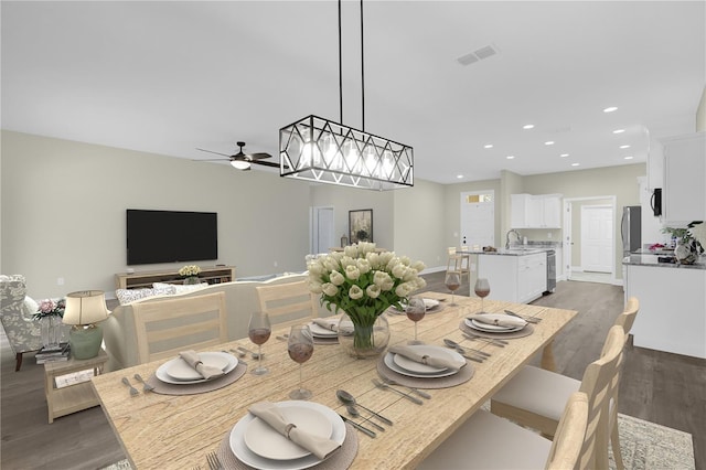 dining room featuring ceiling fan, dark hardwood / wood-style flooring, and sink