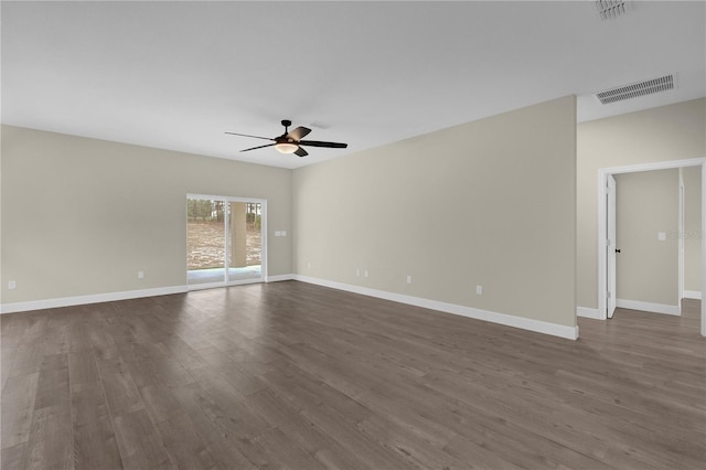 spare room with ceiling fan and dark wood-type flooring