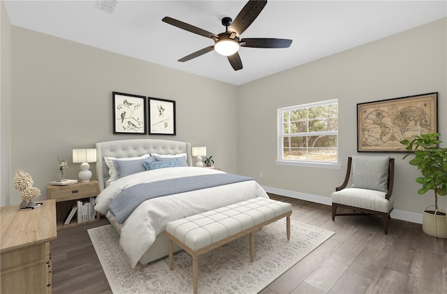 bedroom with ceiling fan and dark wood-type flooring