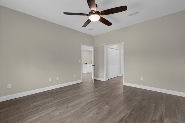 empty room with ceiling fan and dark hardwood / wood-style floors