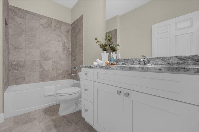 full bathroom with vanity, tiled shower / bath combo, and toilet