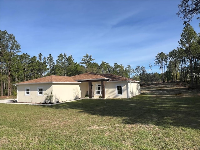 12205 SW 71st Lane Rd, Ocala, FL 34481 - rear view of house featuring a yard and stucco siding