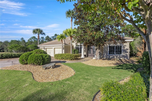 view of front facade featuring a garage and a front lawn