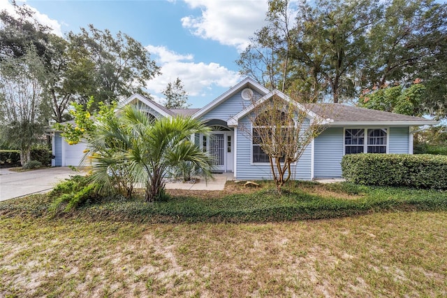 view of front of property with a front lawn and a garage