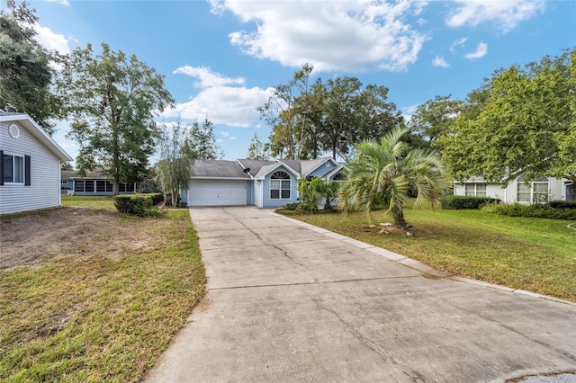 ranch-style house with a garage and a front lawn