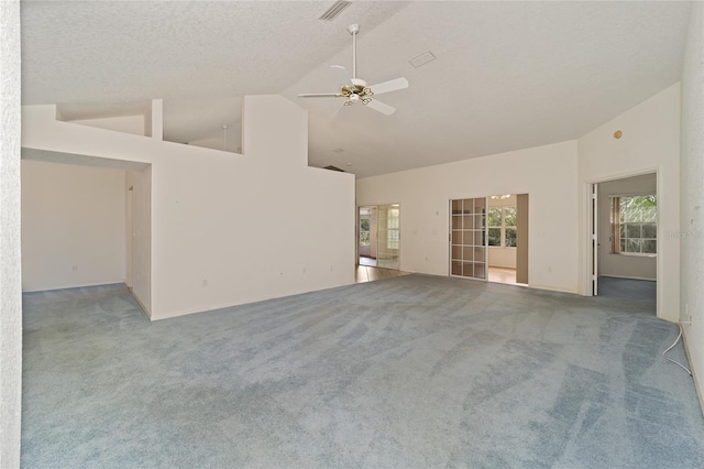 unfurnished living room with carpet floors, ceiling fan, high vaulted ceiling, and a textured ceiling