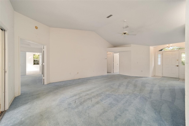 interior space with ceiling fan, light colored carpet, and lofted ceiling