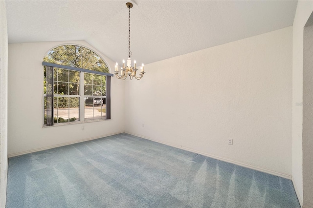 carpeted spare room with a notable chandelier, a textured ceiling, and vaulted ceiling