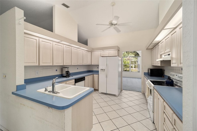 kitchen featuring kitchen peninsula, white appliances, sink, light tile patterned floors, and high vaulted ceiling