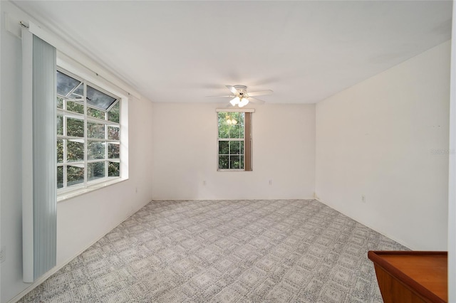 carpeted spare room with ceiling fan