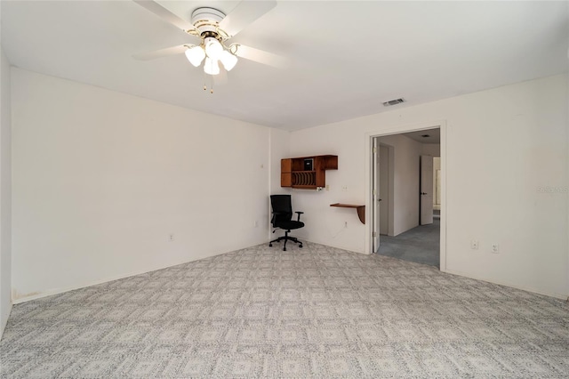 unfurnished room with ceiling fan and light colored carpet