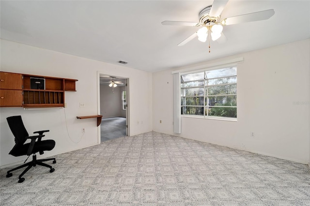 carpeted empty room featuring ceiling fan