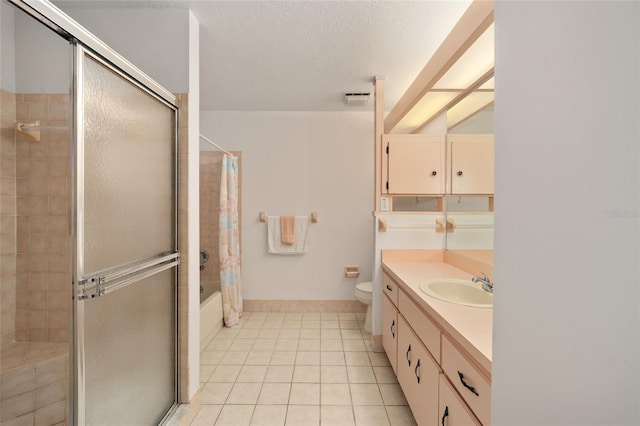 full bathroom featuring a textured ceiling, vanity, tile patterned flooring, toilet, and tiled shower / bath