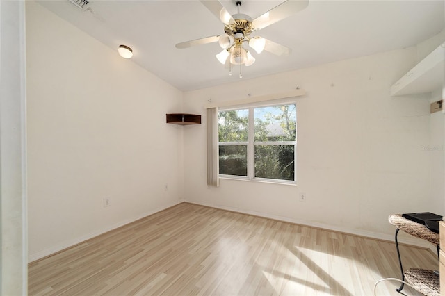 spare room with light wood-type flooring and ceiling fan