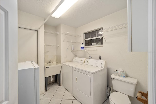 bathroom featuring tile patterned floors, toilet, a textured ceiling, and independent washer and dryer