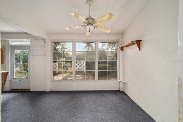 unfurnished sunroom featuring plenty of natural light and ceiling fan