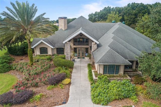 craftsman house with french doors and a balcony