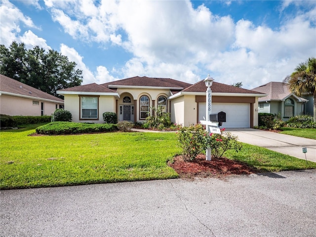 view of front facade with a garage and a front yard