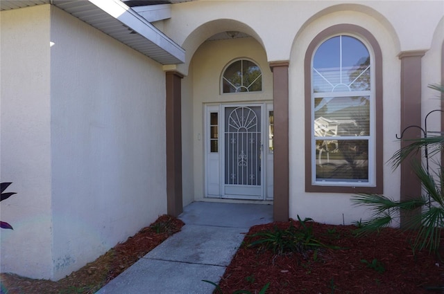 property entrance with stucco siding