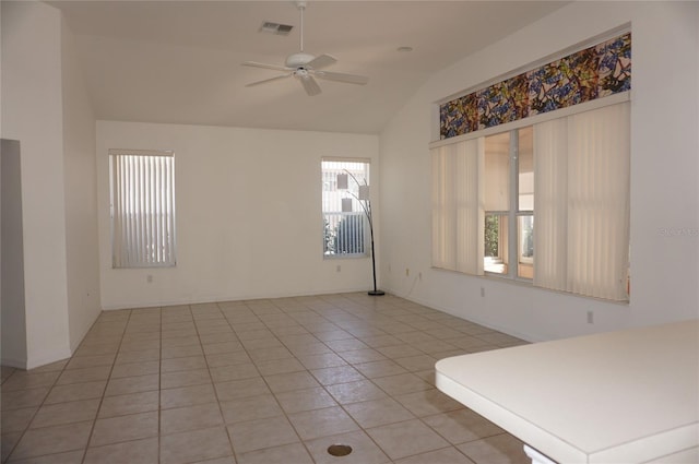 tiled empty room with lofted ceiling and ceiling fan