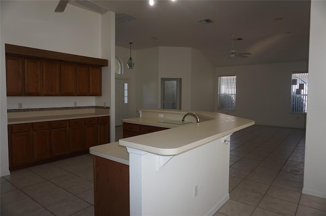 kitchen with ceiling fan, a kitchen island with sink, sink, and a kitchen breakfast bar