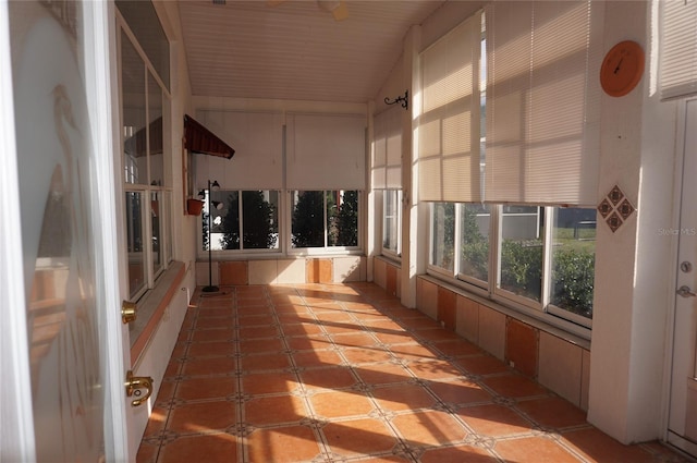 unfurnished sunroom featuring vaulted ceiling