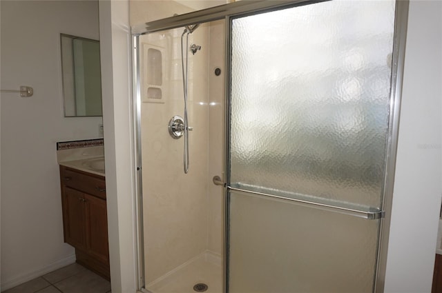 bathroom with vanity, tile patterned flooring, and a shower with door