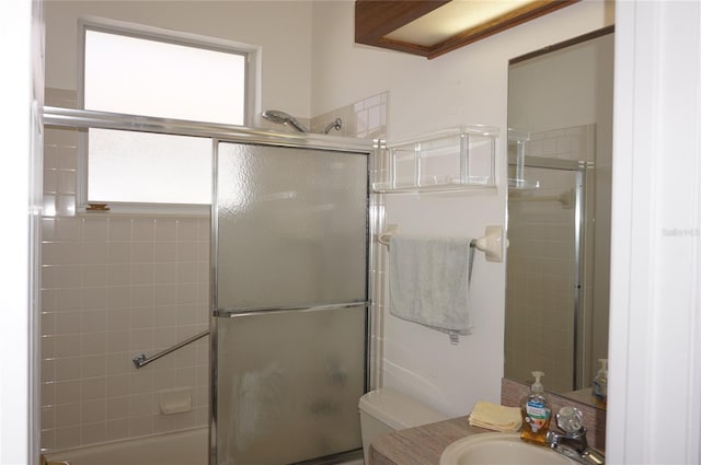 full bathroom with vanity, shower / bath combination with glass door, and toilet