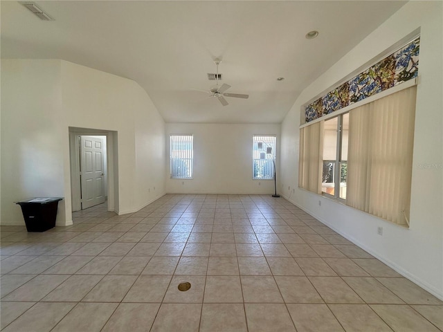 spare room featuring light tile patterned floors, ceiling fan, lofted ceiling, and visible vents